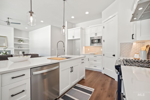 kitchen featuring a sink, white cabinetry, appliances with stainless steel finishes, extractor fan, and ceiling fan
