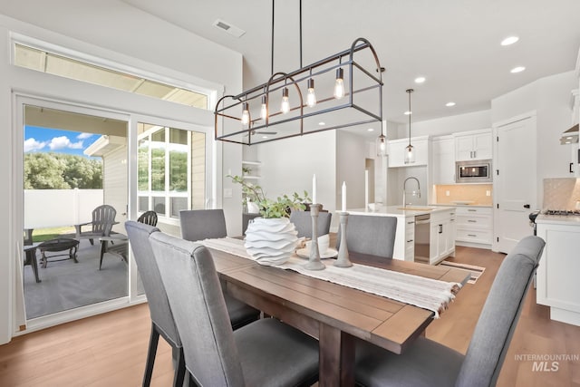 dining area with visible vents, recessed lighting, and light wood-style floors