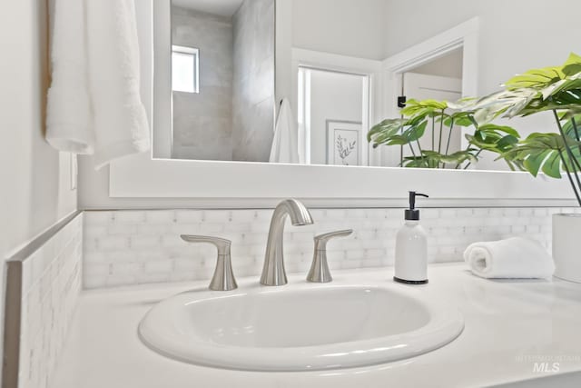 room details featuring decorative backsplash and a sink