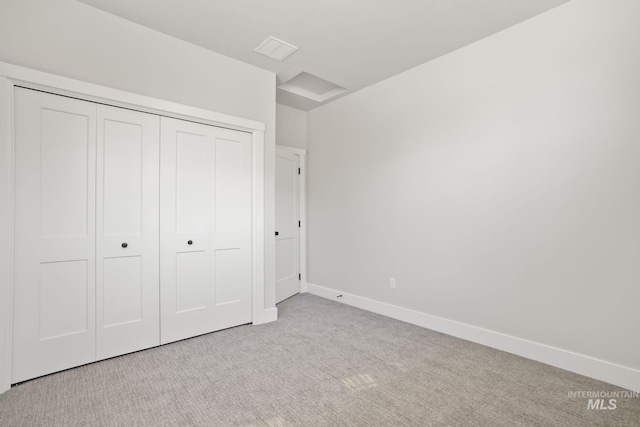 unfurnished bedroom with visible vents, carpet, baseboards, and a closet