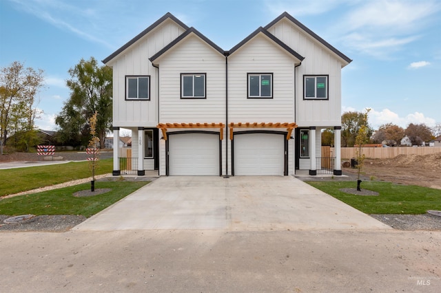 view of front of home featuring a front lawn, a garage, board and batten siding, and concrete driveway