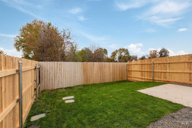 view of yard featuring a patio and a fenced backyard