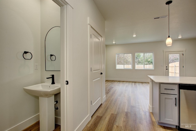 interior space featuring recessed lighting, light wood-style flooring, visible vents, and baseboards