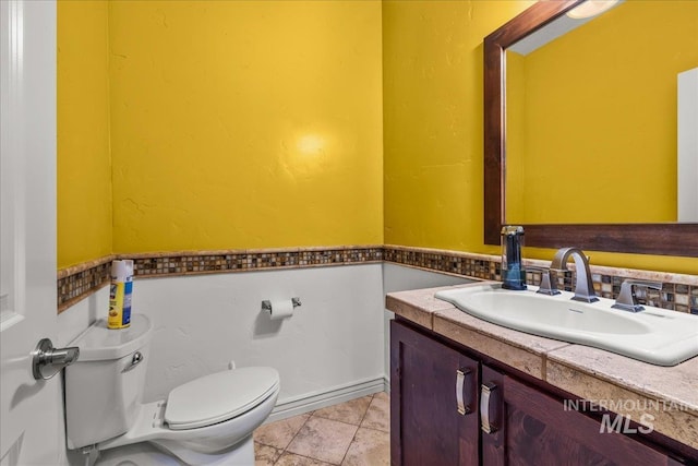 bathroom with toilet and vanity