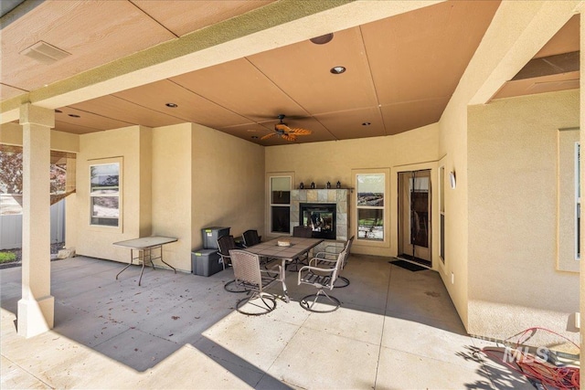 view of patio with outdoor dining space and ceiling fan