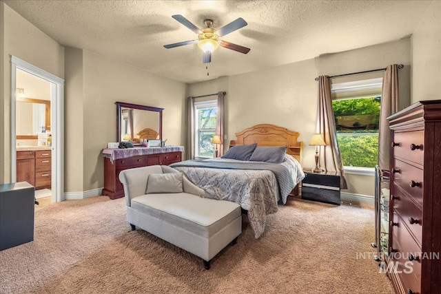 bedroom featuring a textured ceiling, baseboards, ceiling fan, and light colored carpet