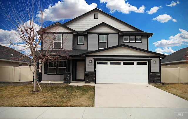 craftsman-style house featuring a garage, a gate, fence, and concrete driveway