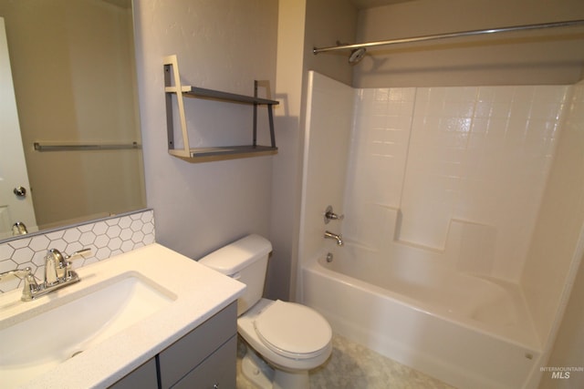 bathroom with tasteful backsplash, vanity, toilet, and shower / bathtub combination