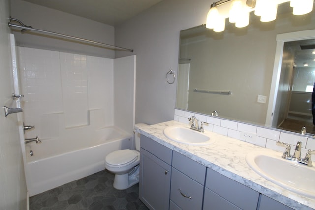 full bath featuring toilet, shower / tub combination, decorative backsplash, and a sink