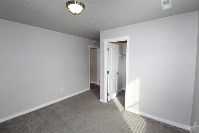 unfurnished bedroom with carpet, visible vents, and baseboards