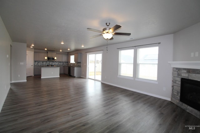 unfurnished living room with dark wood-style floors, a fireplace, recessed lighting, a ceiling fan, and baseboards