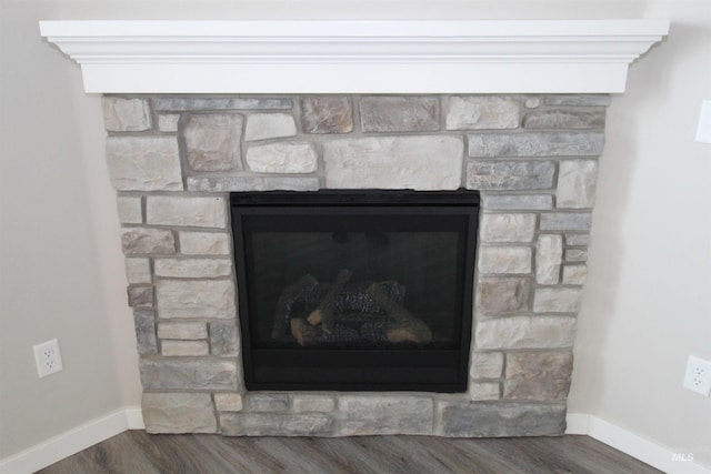 details with a fireplace, baseboards, and wood finished floors