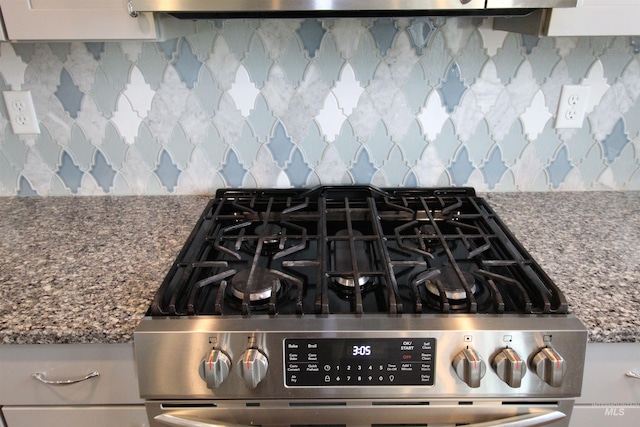 details with stainless steel gas stove, stone counters, decorative backsplash, and exhaust hood