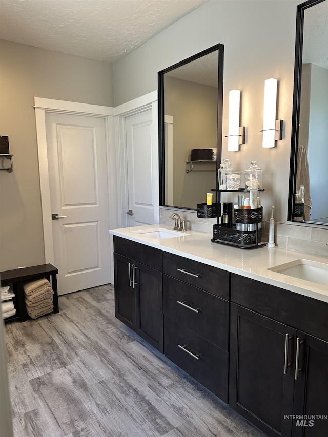 bathroom featuring vanity, a textured ceiling, and hardwood / wood-style flooring