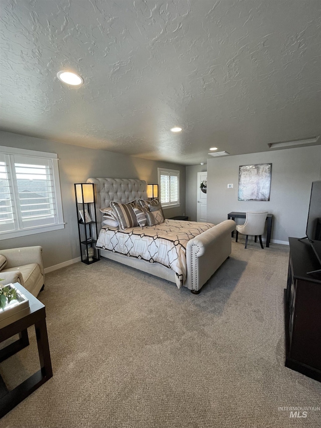 carpeted bedroom featuring a textured ceiling