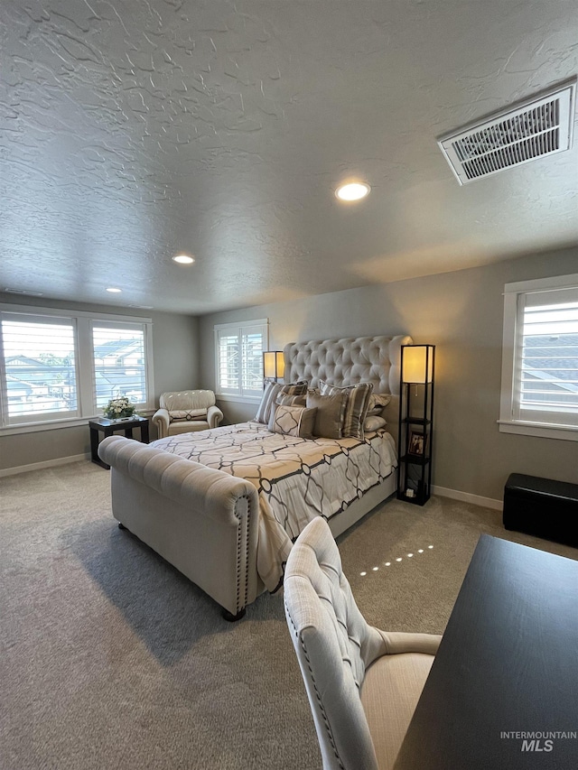 bedroom with a textured ceiling and carpet floors