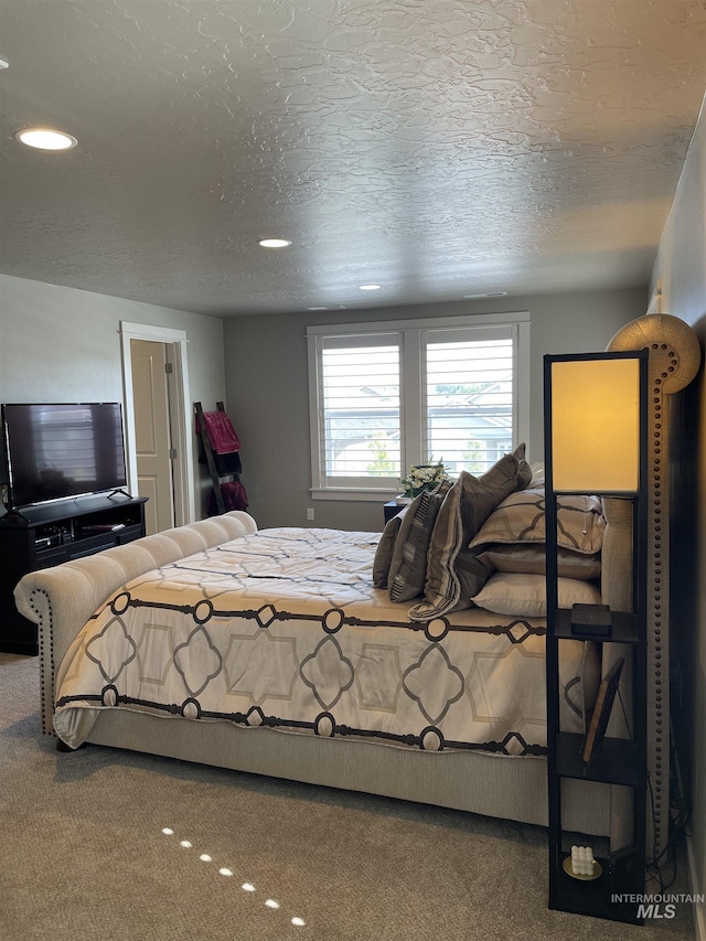 carpeted bedroom featuring a textured ceiling