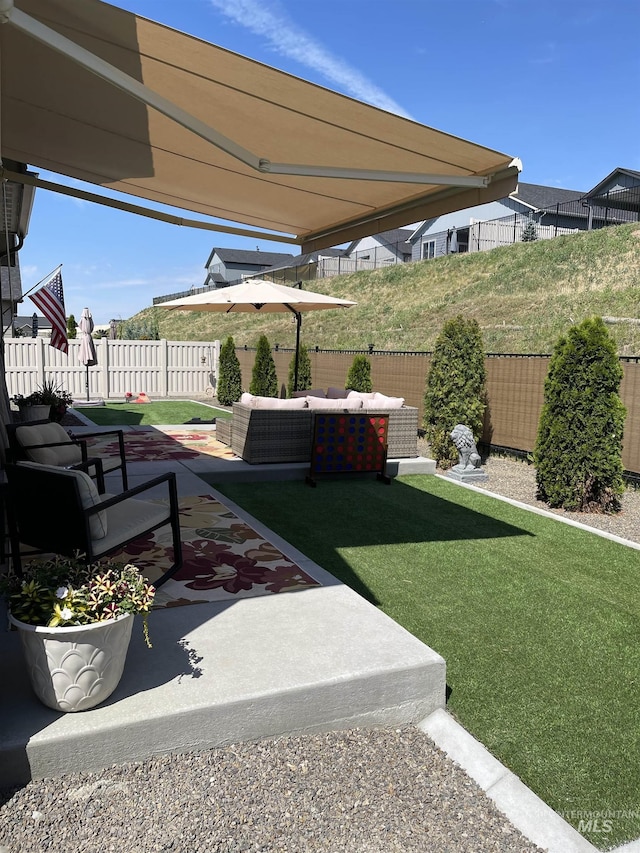 view of yard with outdoor lounge area and a patio