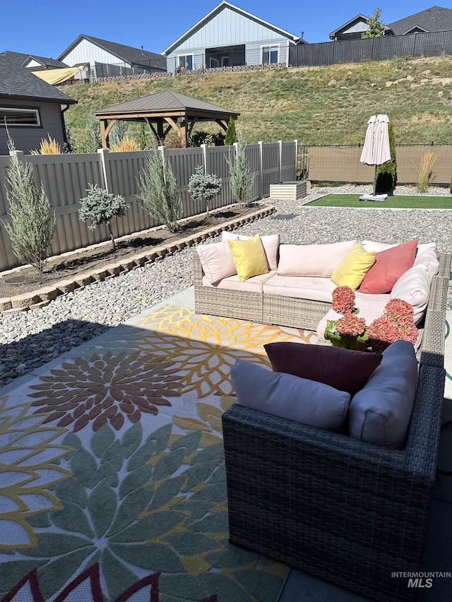 view of patio / terrace with an outdoor living space and a gazebo