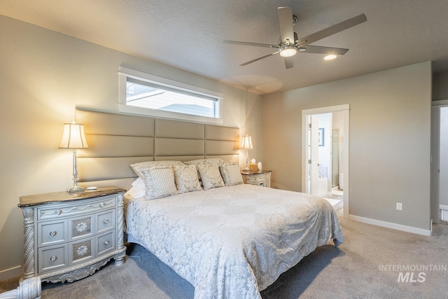 bedroom with ceiling fan, light carpet, connected bathroom, and a textured ceiling