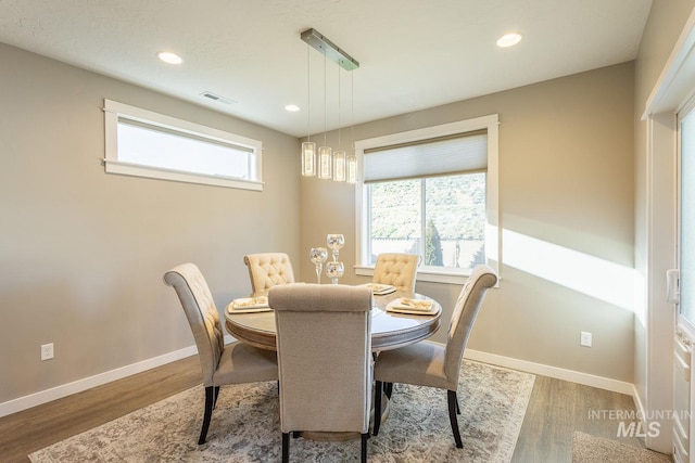 dining space featuring wood-type flooring