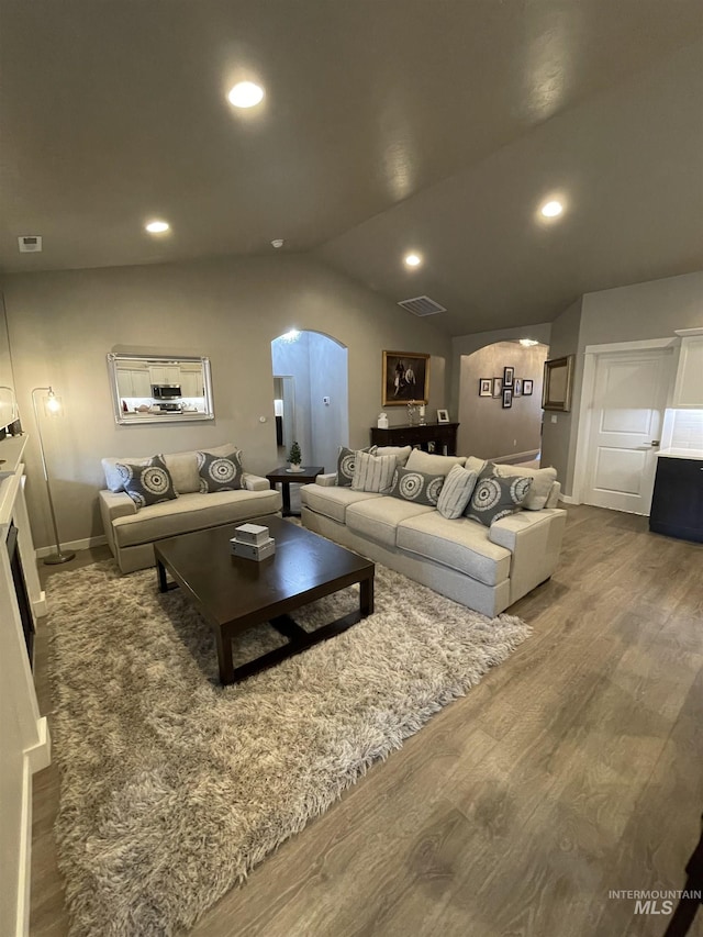 living room with lofted ceiling and hardwood / wood-style flooring