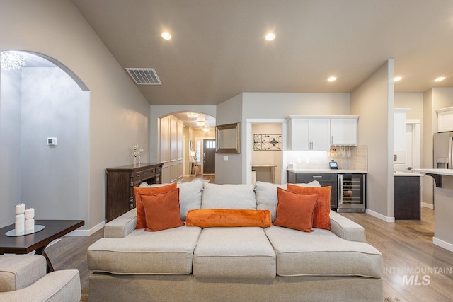 living room featuring light hardwood / wood-style floors and wine cooler