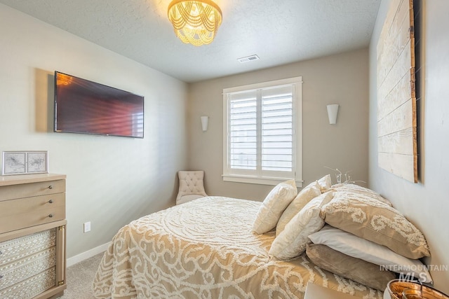 bedroom with a textured ceiling and carpet flooring