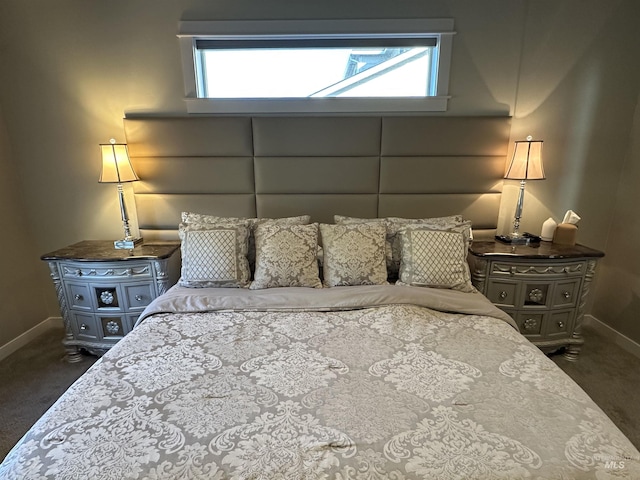 bedroom with multiple windows and dark colored carpet