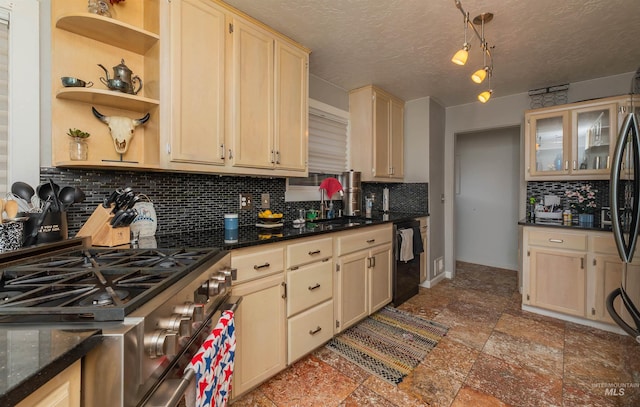 kitchen featuring a textured ceiling, backsplash, black dishwasher, gas range, and a sink