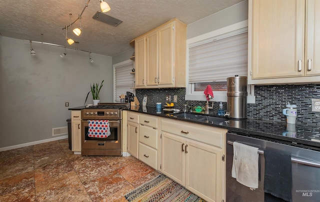 kitchen with visible vents, dark countertops, appliances with stainless steel finishes, a textured ceiling, and backsplash