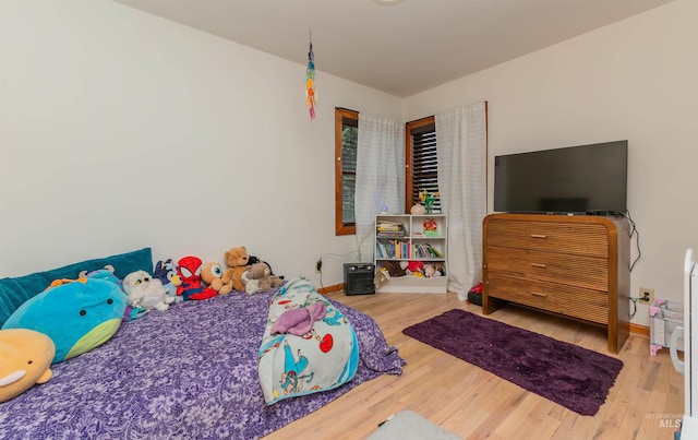 bedroom featuring wood finished floors and baseboards