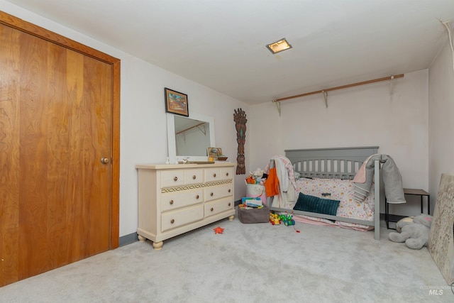 carpeted bedroom with a crib