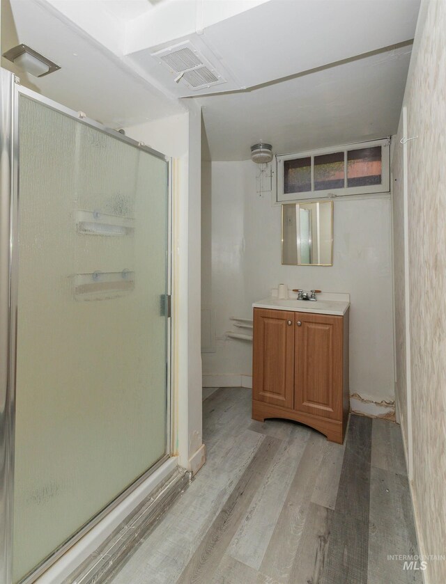 bathroom with visible vents, a shower stall, vanity, and wood finished floors