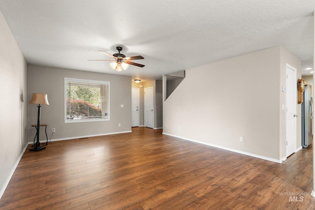 unfurnished living room with baseboards, a ceiling fan, a textured ceiling, and hardwood / wood-style flooring