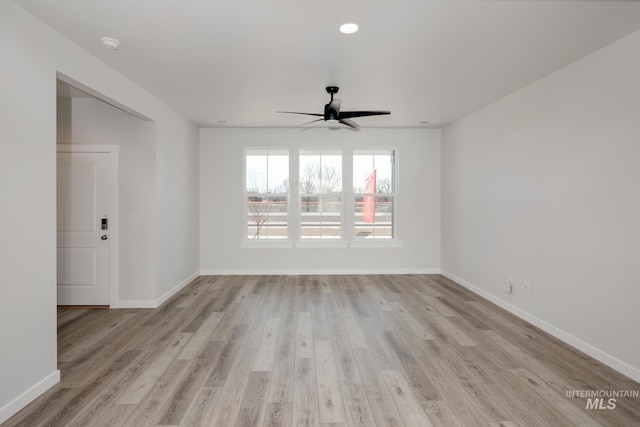 empty room featuring light hardwood / wood-style flooring and ceiling fan