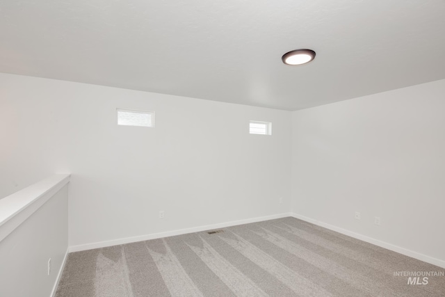 basement featuring carpet flooring and plenty of natural light