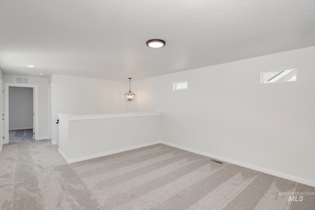 carpeted empty room featuring a wealth of natural light