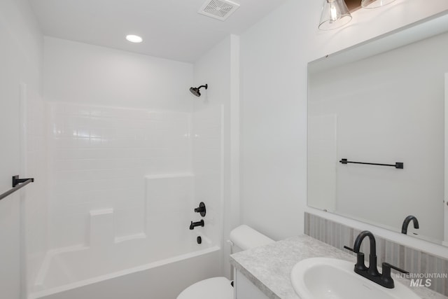 full bathroom with shower / tub combination, vanity, and toilet