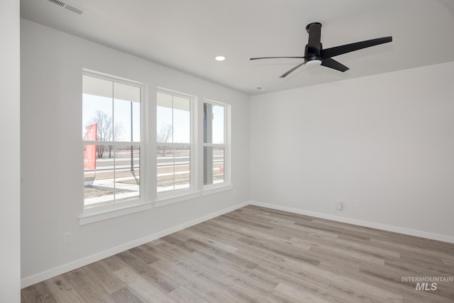 spare room featuring ceiling fan and light hardwood / wood-style flooring