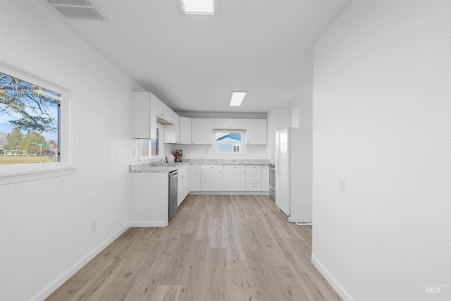 kitchen with sink, light hardwood / wood-style flooring, dishwasher, white cabinetry, and white refrigerator