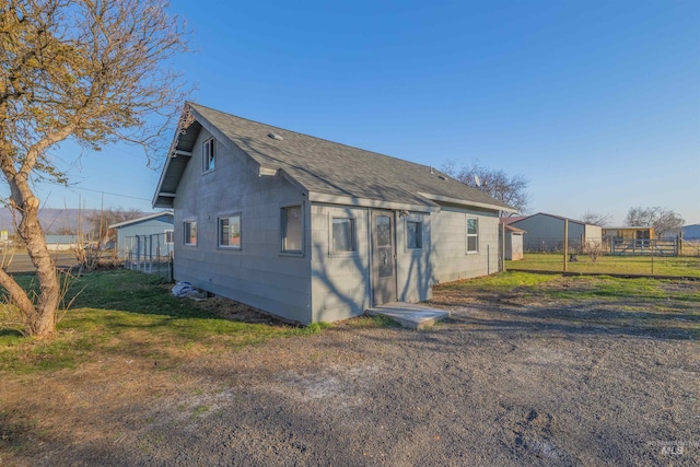 back of property with a yard