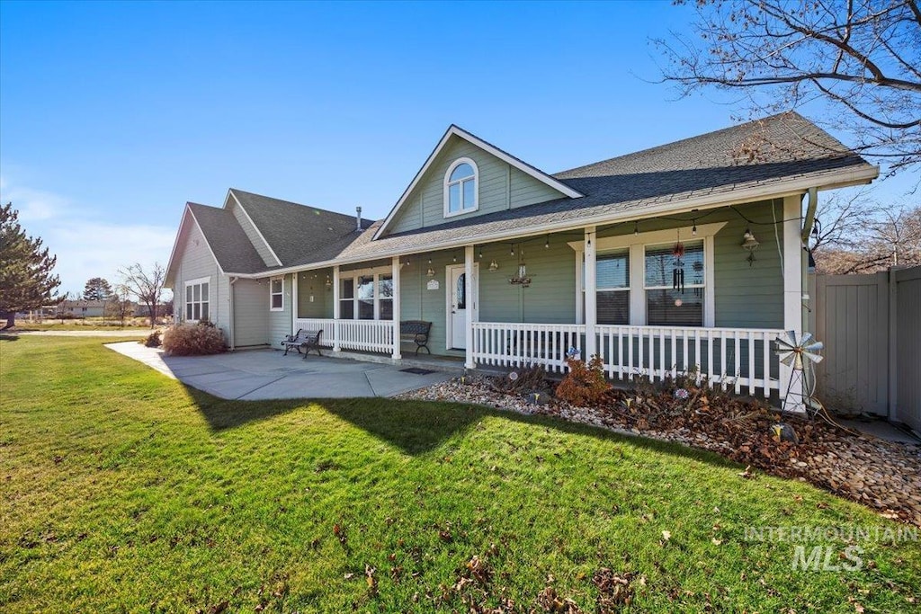 view of front of house with a porch and a front yard