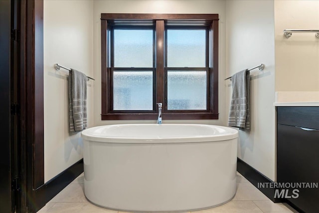 bathroom featuring tile patterned floors, vanity, and a bathing tub