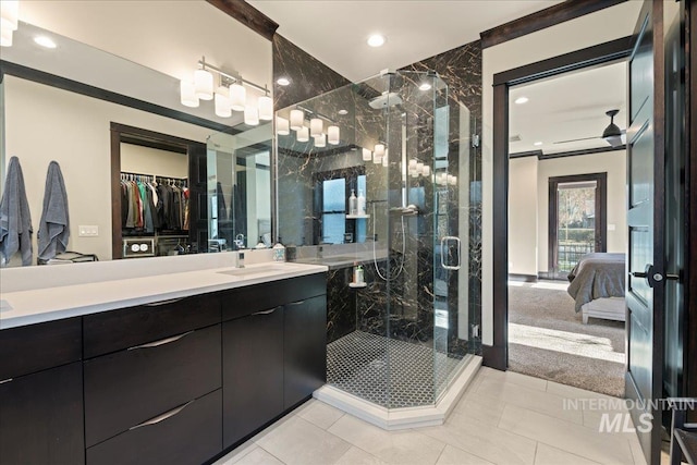 bathroom with vanity, tile patterned floors, and a shower with door