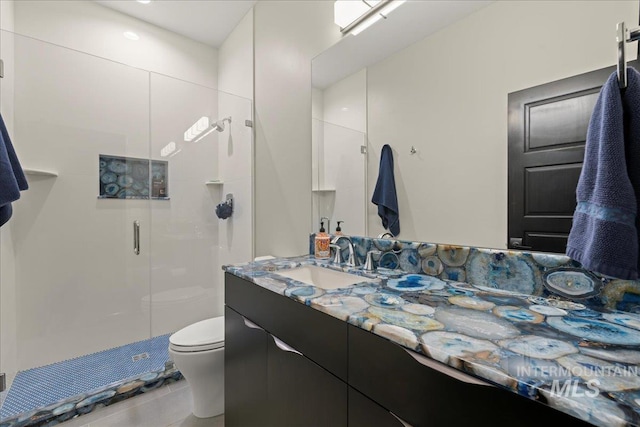 bathroom with toilet, vanity, tile patterned flooring, and an enclosed shower