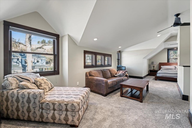 carpeted living room featuring ceiling fan and lofted ceiling