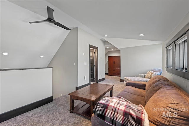 living room featuring ceiling fan, carpet, and lofted ceiling