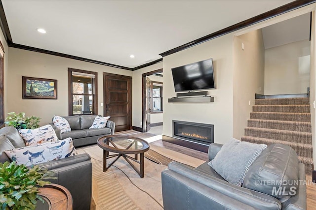 living room with light hardwood / wood-style floors and crown molding