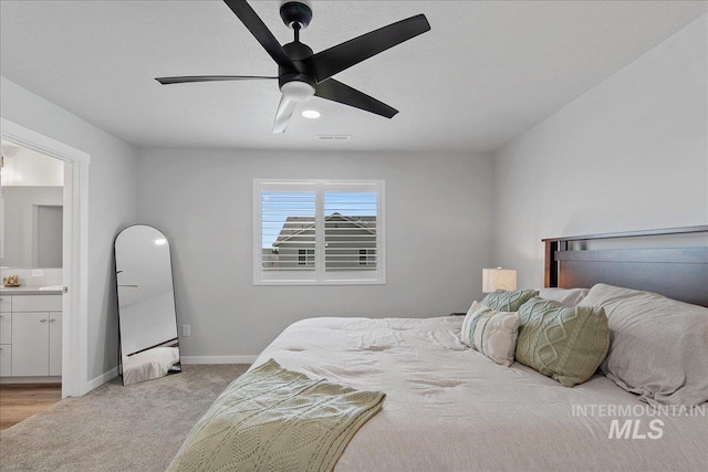 4953 W Apgar St, Meridian, ID 83646 - bedroom with light colored carpet, baseboards, ensuite bathroom, and ceiling fan